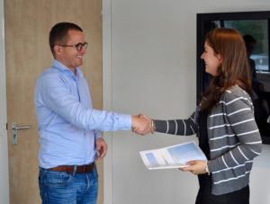 Sales Professional shaking hands with a happy customer.