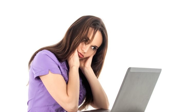 Image of girl being very tired at the computer